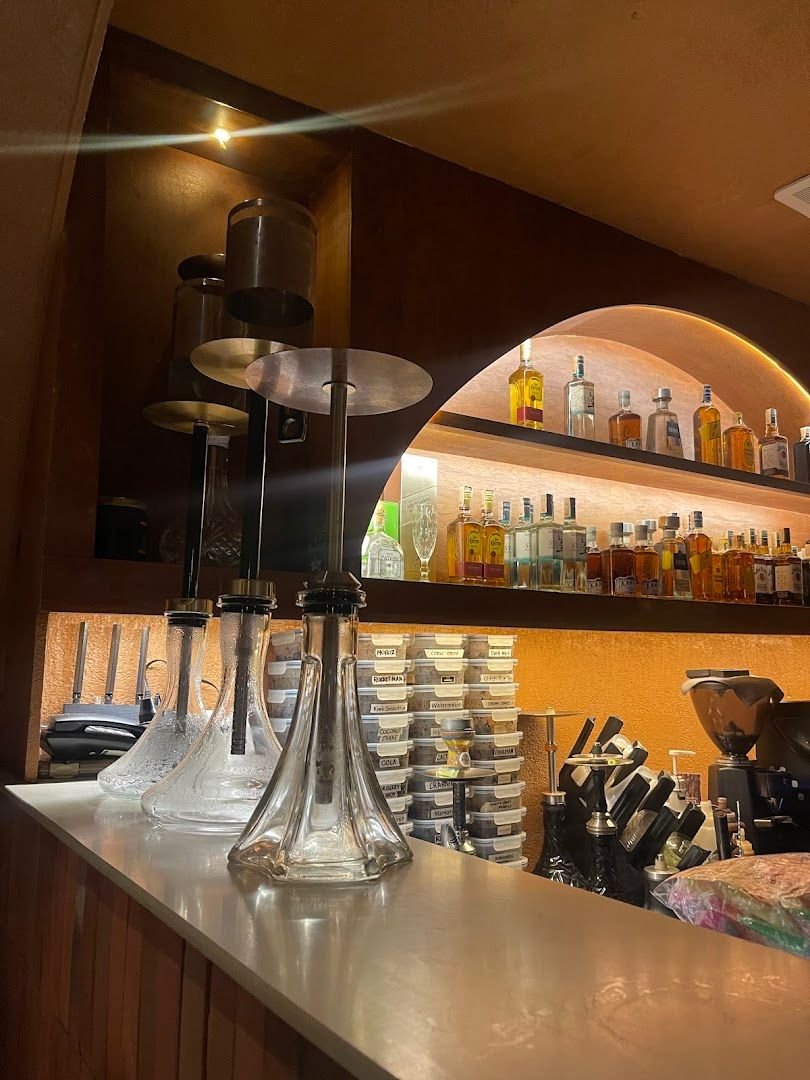Bar area with hookah pipes and premium spirits on display